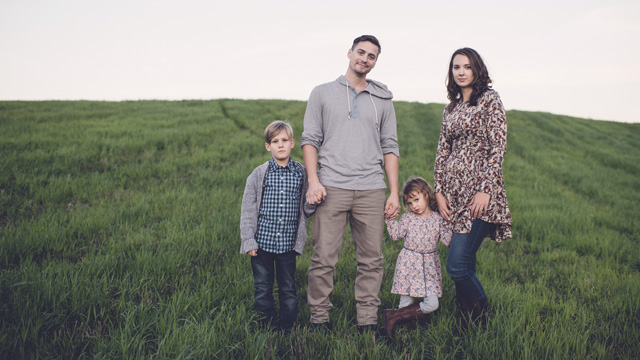 Family with two kids on green field - Small