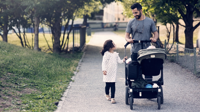 Man walking with kid and a stroller - Small