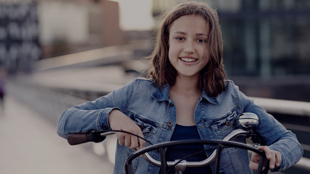young girl on bicycle closeup small overlay