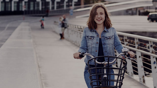 Young girl on bicycle.