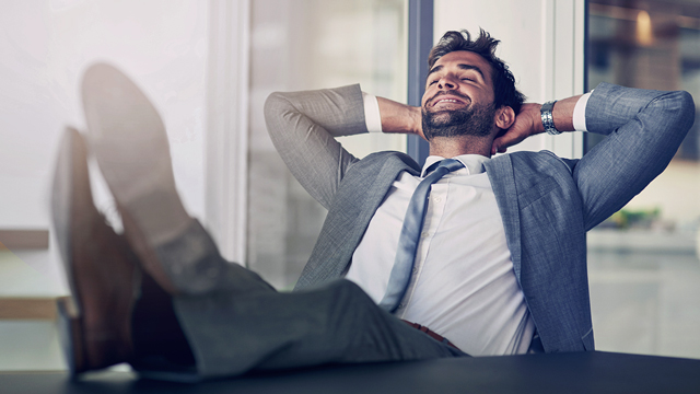 relaxed man leaning back in his office chair