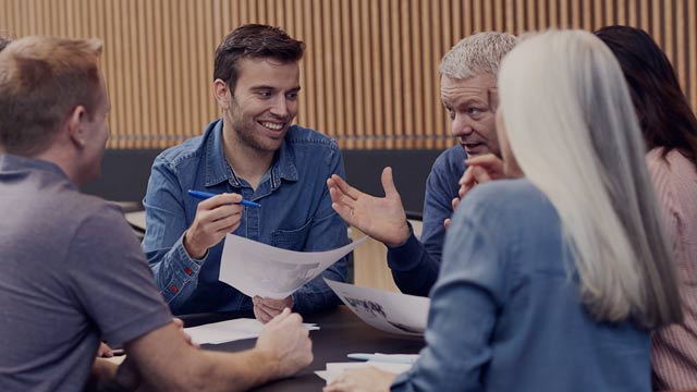 group of people working around table 5 small overlay