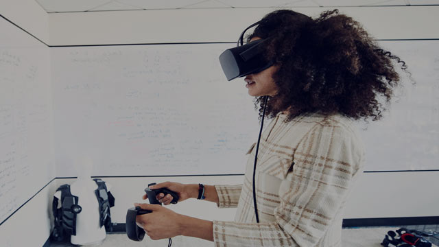 female engineer testing program on virtual reality headset small overlay