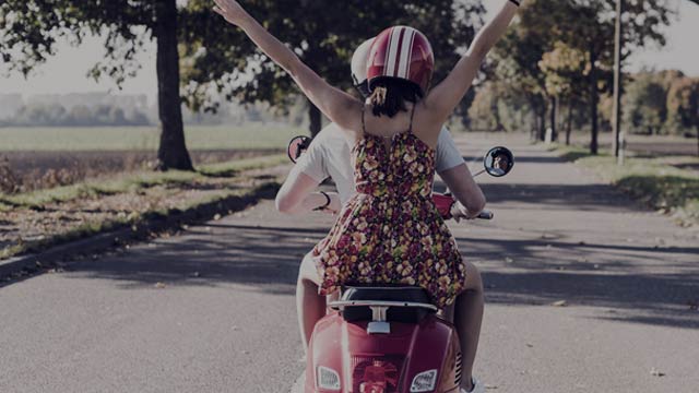 Two people on scooter