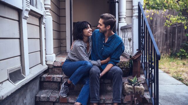 happy couple sitting on stairs embracing