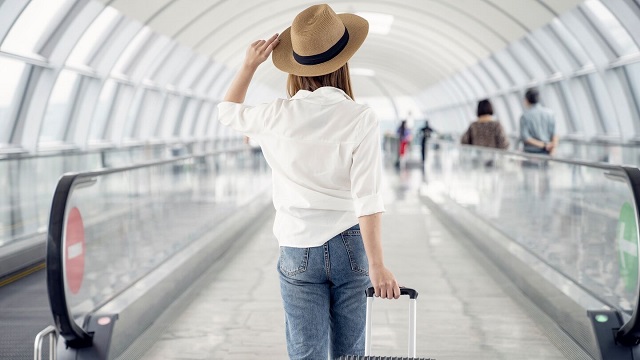 Young casual female traveler at airport - small overlay