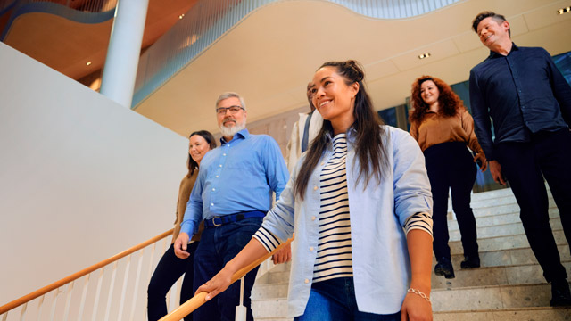 Woman colleagues walking on stairs SMALL