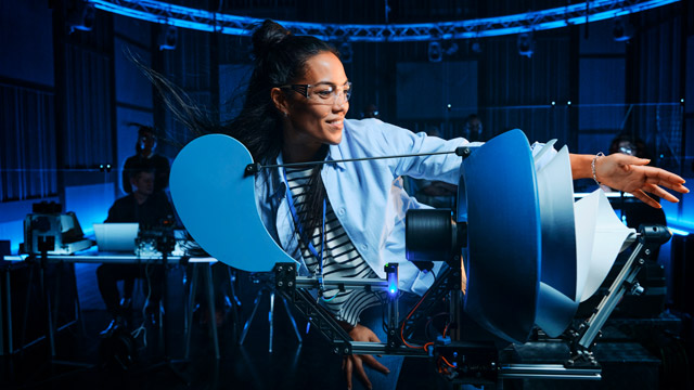 Green tech woman demonstrating her windmill invention SMALL