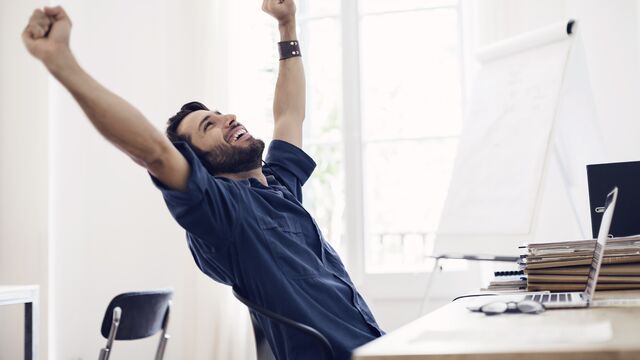 businessman stretching at desk 640x360