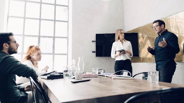 Male-and-female-colleagues-discussing-at-workplace-small