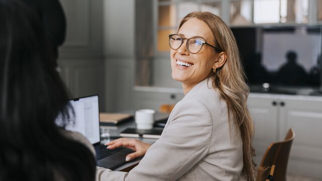 Female coworker smiling and working at her desk